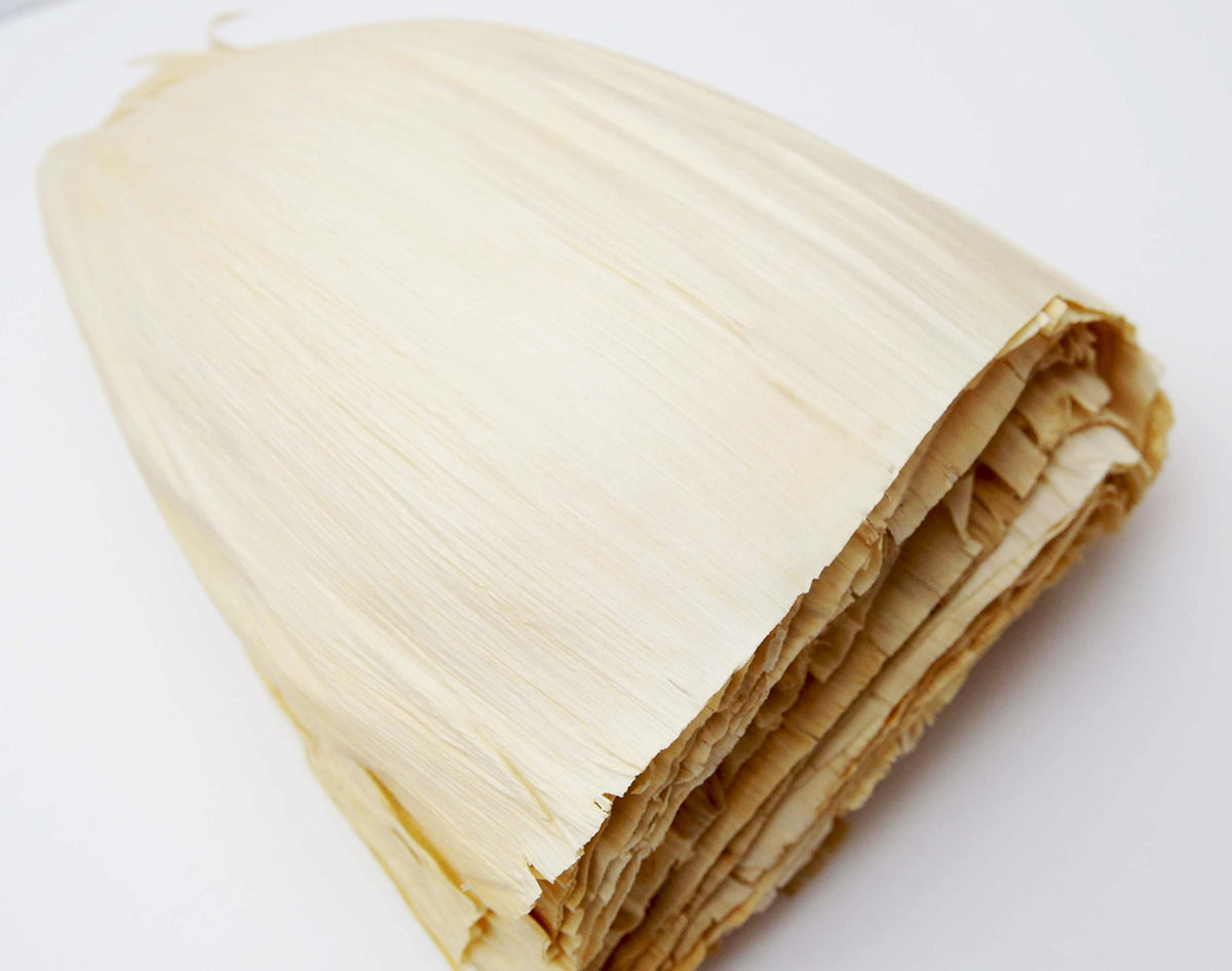 1400S Spices plated tamales showcasing husk-wrapped delights