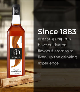 1883 Maison Routin Dulce de Leche Syrup dessert topping image emphasizes creamy drizzle.