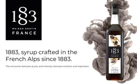 Pouring 1883 MAISON ROUTIN Irish Cream Syrup into a latte for rich flavor