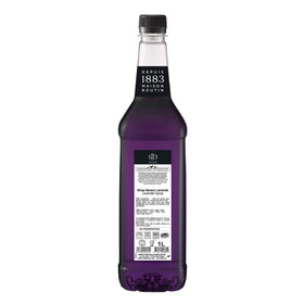 Pouring 1883 MAISON ROUTIN Lavender Syrup into a glass for drinks