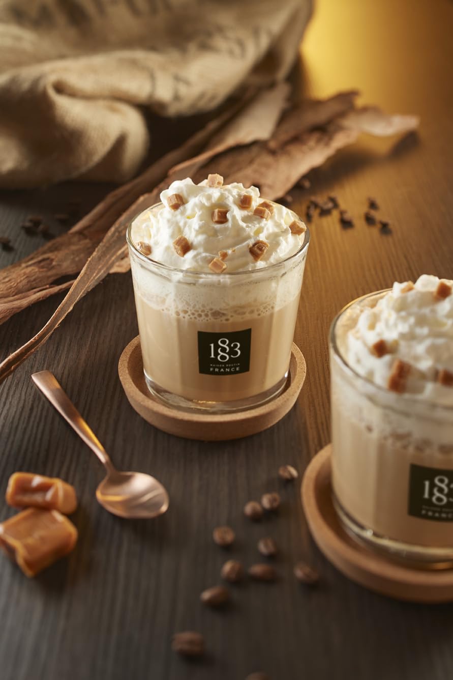 Coffee cup with 1883 sugar-free caramel syrup drizzle for lattes.