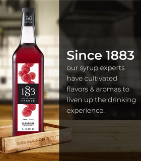 1883 Raspberry Syrup mixed into iced tea for refreshing sweetness.