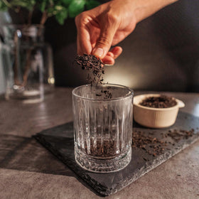 Amber-colored Assam tea liquor in a glass cup