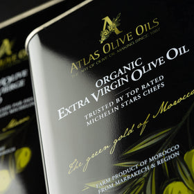 A ATLAS OLIVE OILS olive harvest tree scene emphasizing fresh olives