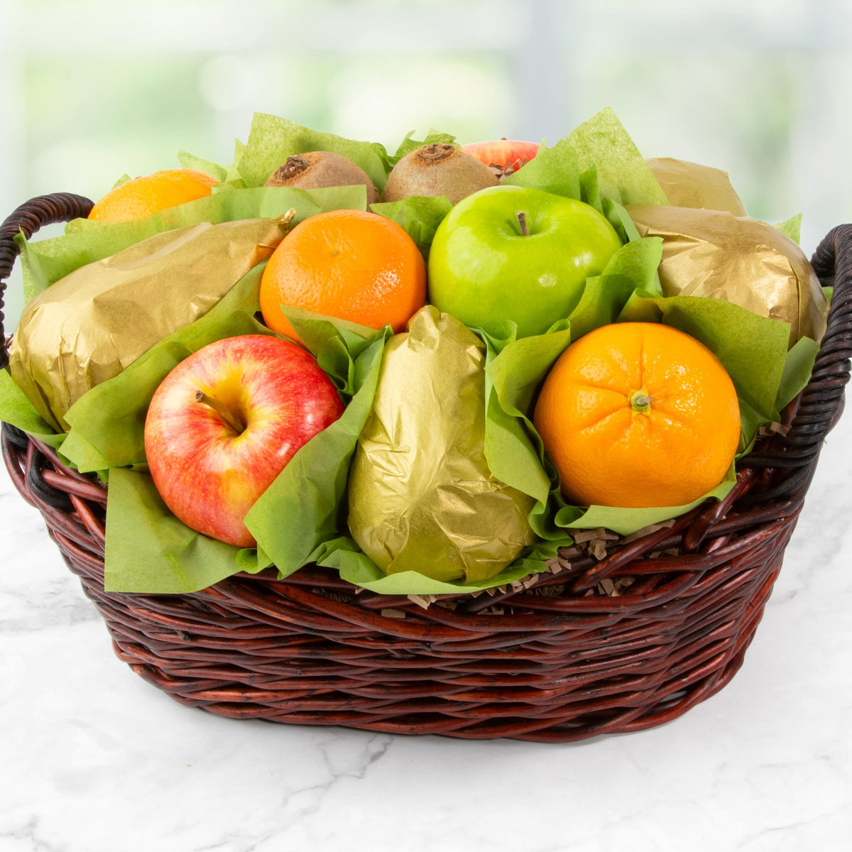 A Gift Inside Harvest Gold apples and citrus arrangement showcased for celebrations.