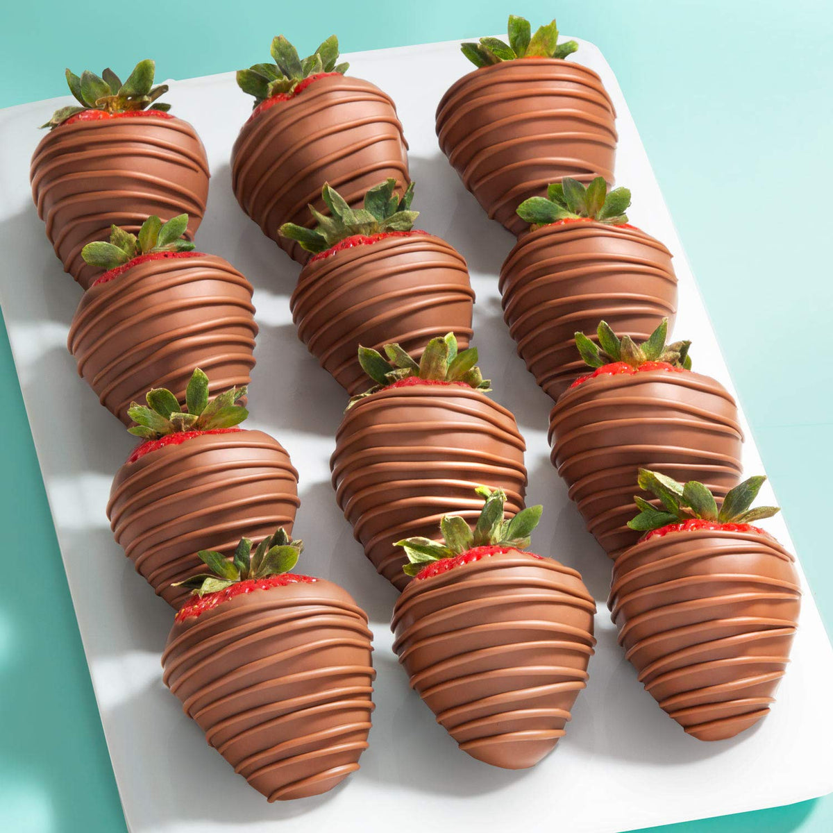 A Gift Inside Milk Madness strawberries closeup shows glossy milk chocolate and indulgent texture.