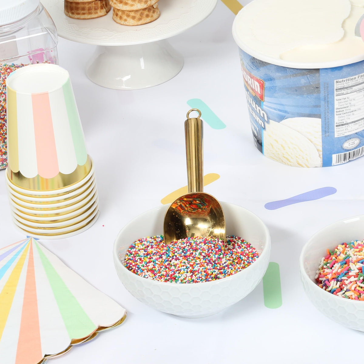 A Great Surprise rainbow nonpareils adorning cupcakes for bright tops