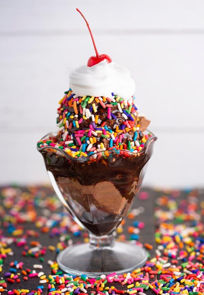 Cake decorating with A Great Surprise Rainbow Sprinkles on frosted layers