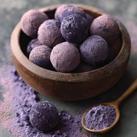 Addictive Wellness Purple Cacao Powder spoon close-up for baking and no-bake desserts