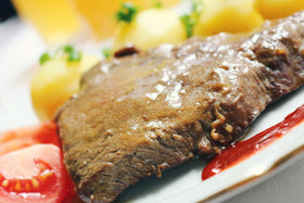 Adkins Ranch Style Steak Seasoning on steak shows rich color and aroma.