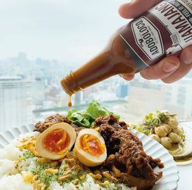 Adoboloco Hamajang on the grill over smoky meat.