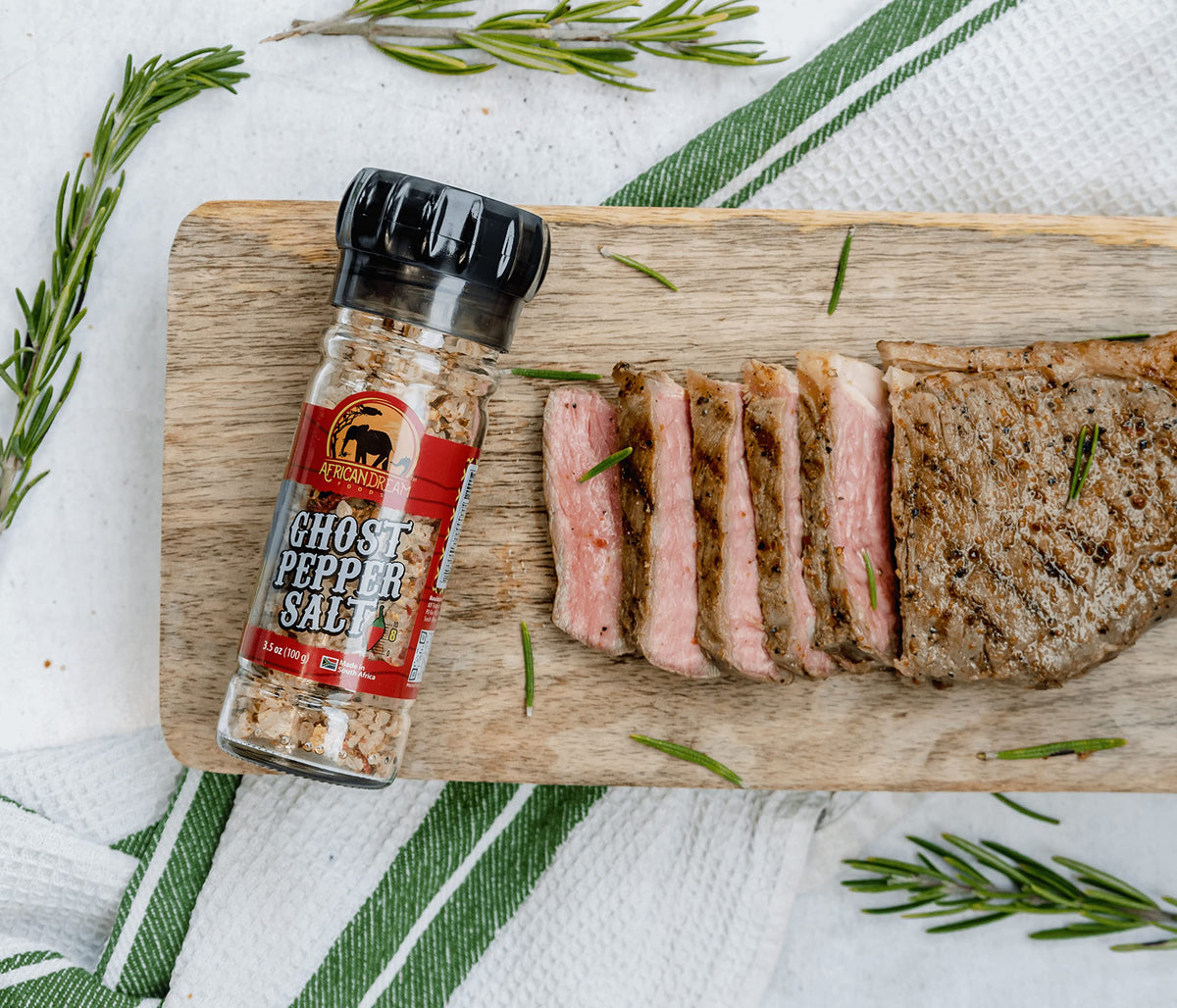 African Dream Foods Ghost Pepper Salt bottle and grinder shown with reusable packaging.