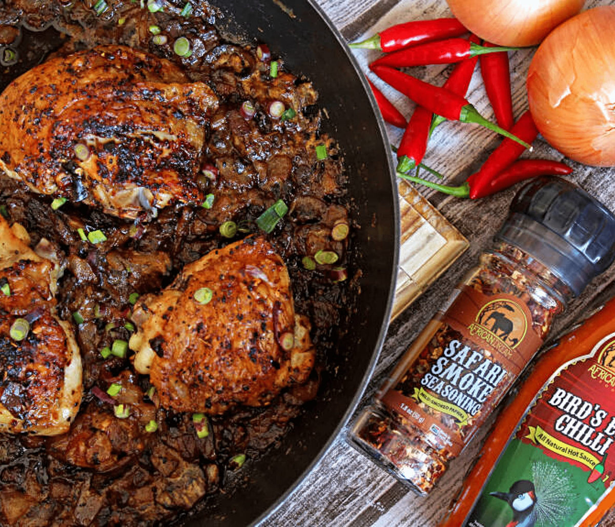 African Dream Foods Safari Smoke Seasoning grinder lid in use on a countertop.