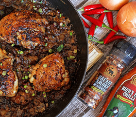 African Dream Foods Safari Smoke Seasoning grinder lid in use on a countertop.