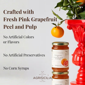 Glass jar display of Agrisicilia marmalade on a kitchen counter, ready to glaze seafood or desserts.