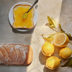 Agrisicilia marmalade with tea cup, pairs well with hot beverages.