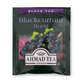 Serving glass of iced Ahmad Tea Blackcurrant Burst, a cool berry treat on warm days.
