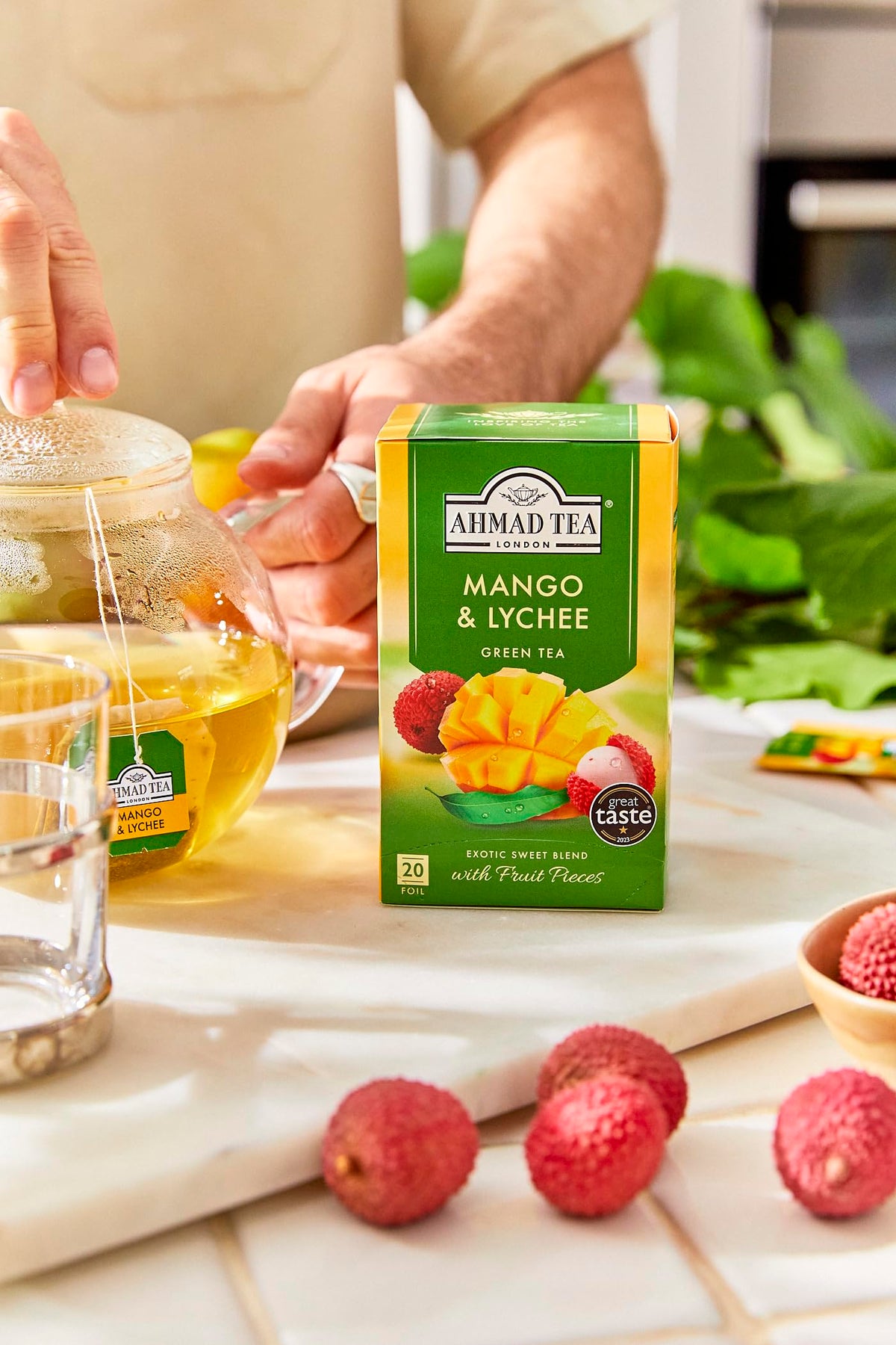 Ahmad Tea Mango & Lychee brewed tea in a cup with bright aroma.