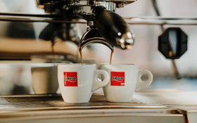 Aiello Caffe espresso with cup showcasing rich crema and full-bodied taste.