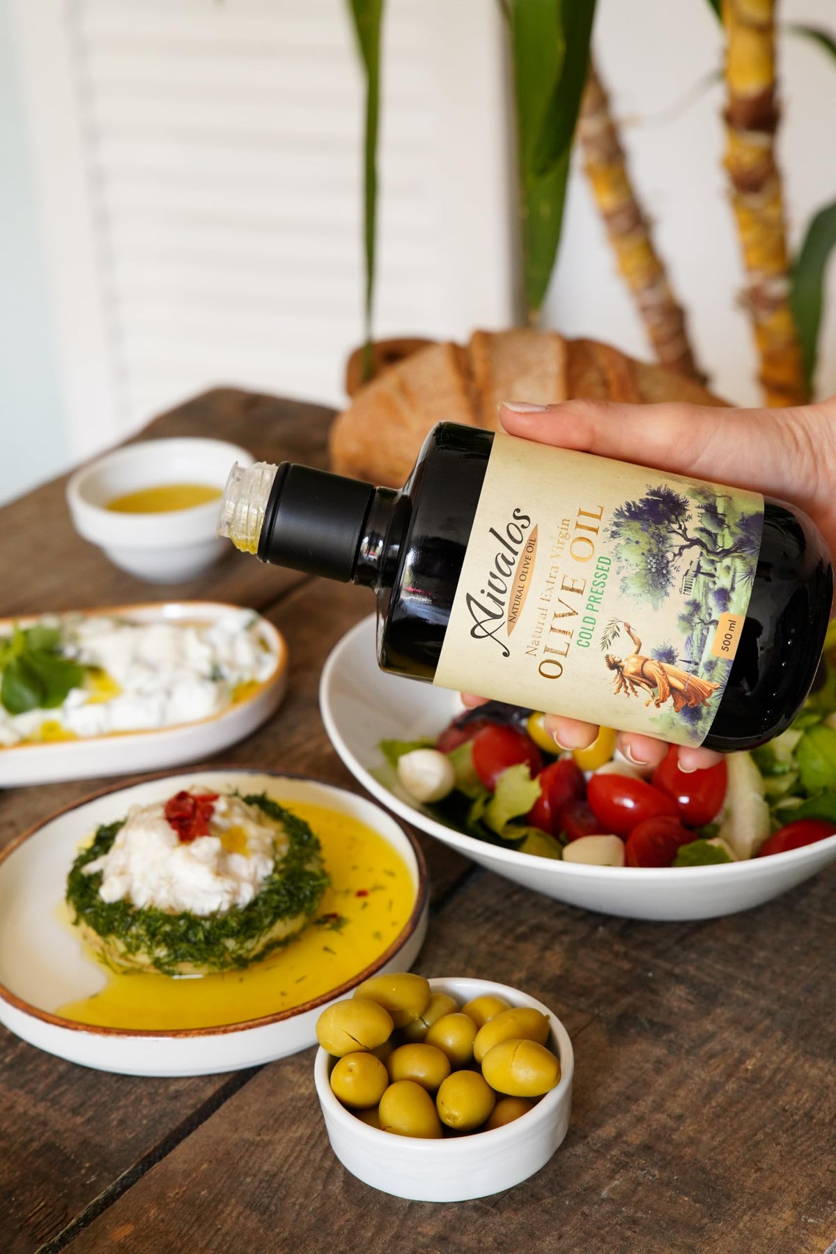AIVALOS early harvest olive oil pour showing precise drizzle