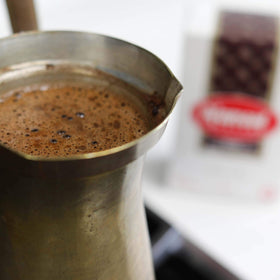 Brand label on Al Ameed packaging emphasizing authentic Arabica sourcing.