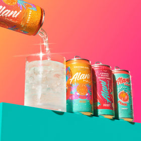 Alani Nu Mini Energy Orange Kiss can sparks bright citrus flavor.