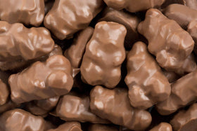 Albanese Milk Chocolate Covered Gummi Bears closeup showing creamy indulgence and bite-sized joy.