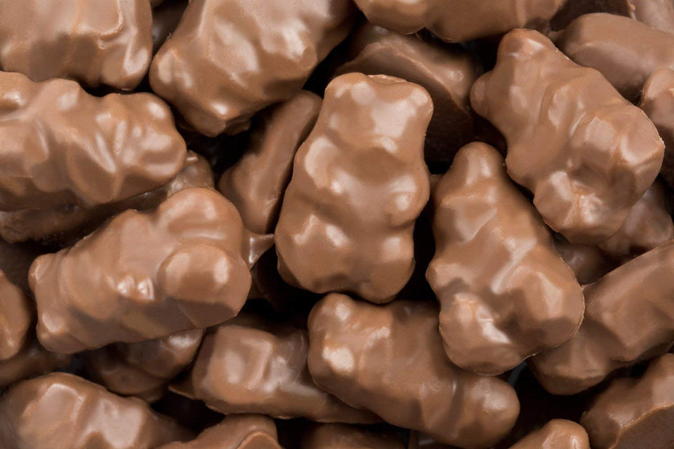 Albanese Milk Chocolate Covered Gummi Bears closeup showing creamy indulgence and bite-sized joy.