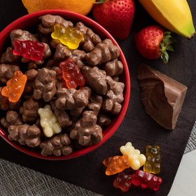 Albanese Milk Chocolate Covered Gummi Bears dunked in chocolate scene highlighting the creamy pairing for snack moments.
