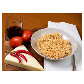 Alessi Autentico risotto with grilled meat side dish on plate.