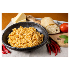 Alessi prepared Arrabbiata pasta in a dish—vibrant color and aroma.