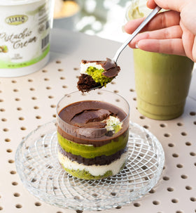 Alkis Pistachio Cream drizzled on a Dubai chocolate bar.