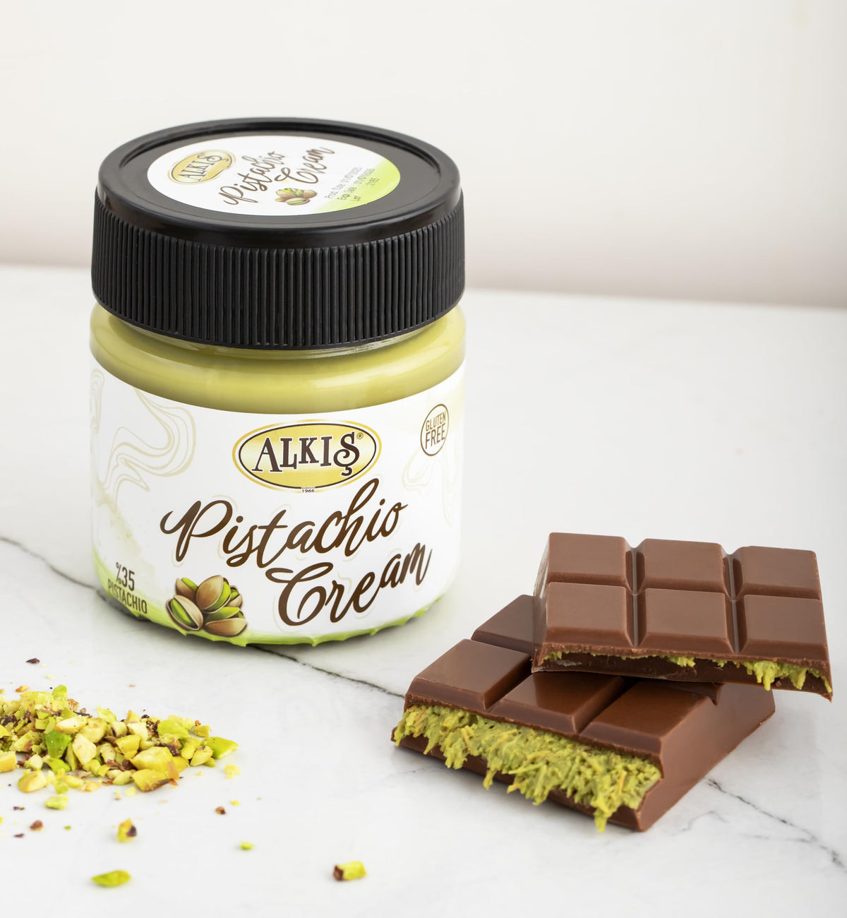 Alkis pistachio cream topping on ice cream highlights indulgent, scoopable texture.