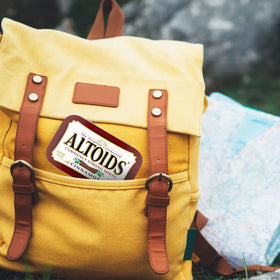 Altoids Cinnamon mints tin tucked in a pocket for portable freshness.