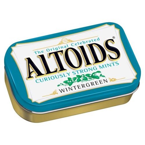 Altoids mints on a desk with packaging for quick desk refresh.