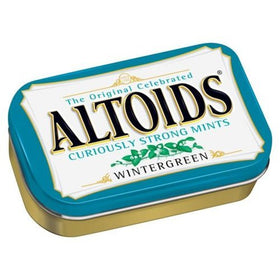 Altoids mints on a desk with packaging for quick desk refresh.