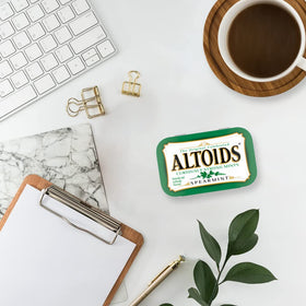 Altoids Spearmint pack on desk highlights everyday carry for quick refresh during the day.