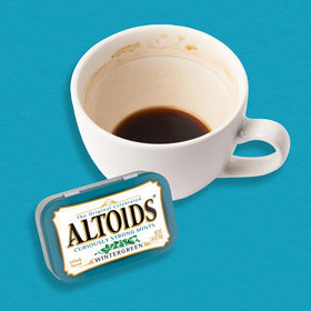 Altoids Wintergreen mint tin open showing mints for immediate breath refresh.