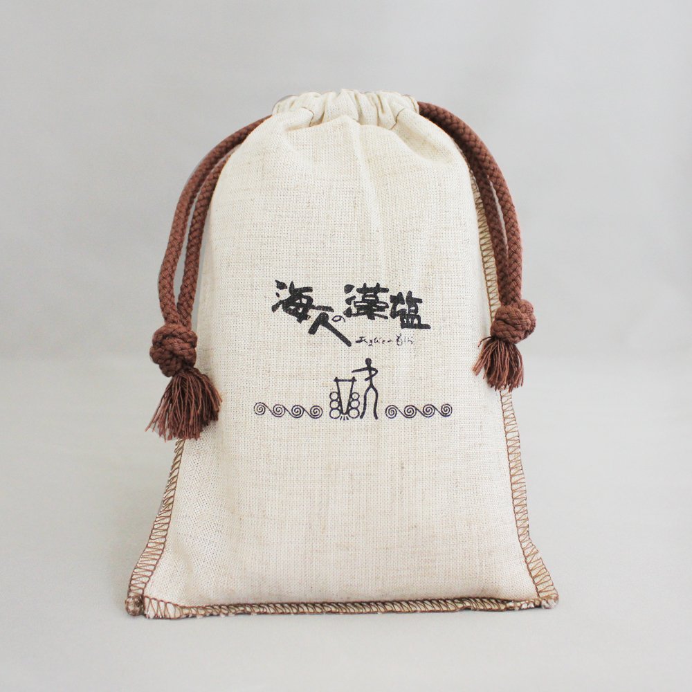 Amabito No Moshio seaweed salt bottle with beige crystals for finishing dishes