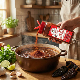 Amazing Chiles & Spices Ancho Chile Powder with a spoon demonstrates precise measurement.