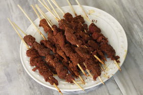 Aminchi Foods Suya spice closeup shows smoky red powder ideal for grilling.