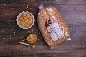 Amish Country Popcorn gluten-free and non-GMO labeling on a bright bag.