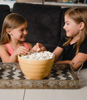 Popping kernels in a pan with Amish Country Popcorn