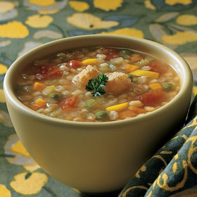 Amy's Organic Vegetable Barley close-up showing tomatoes and carrots in broth.