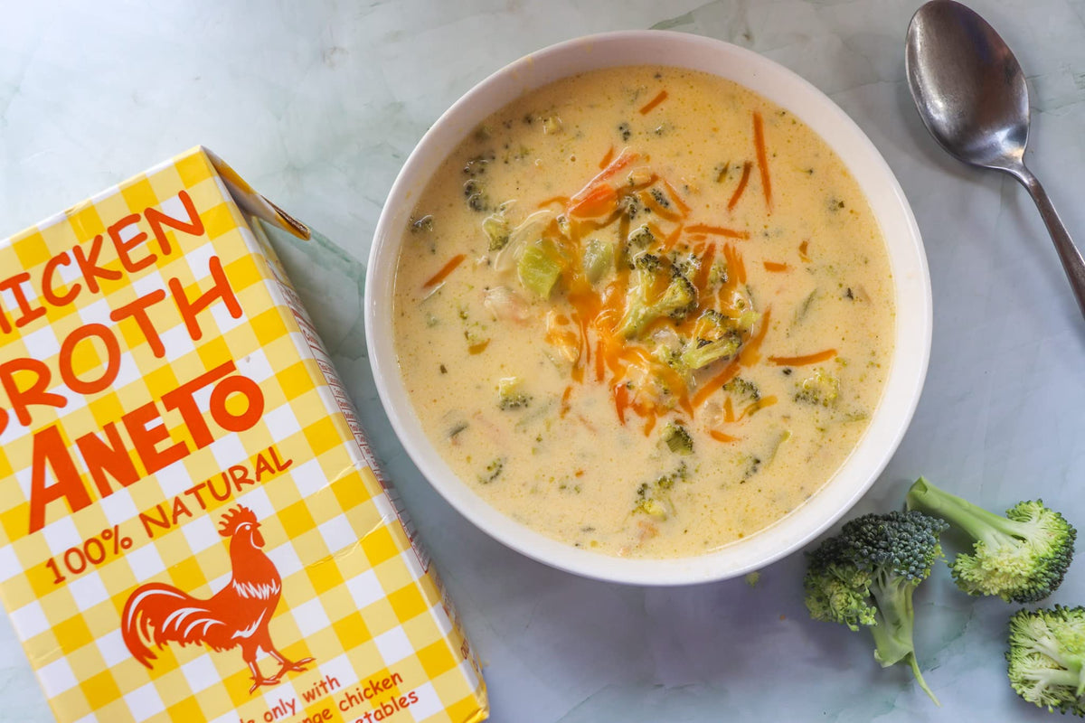 Pouring Aneto broth from a bottle into a pan adds depth of flavor