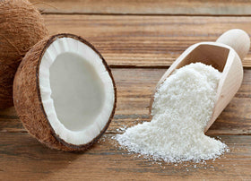 Anna and Sarah shredded coconut in a baking dish as a versatile ingredient