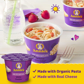 Pack of Annie's Organic White Cheddar Mac and Cheese Cups displayed on shelf