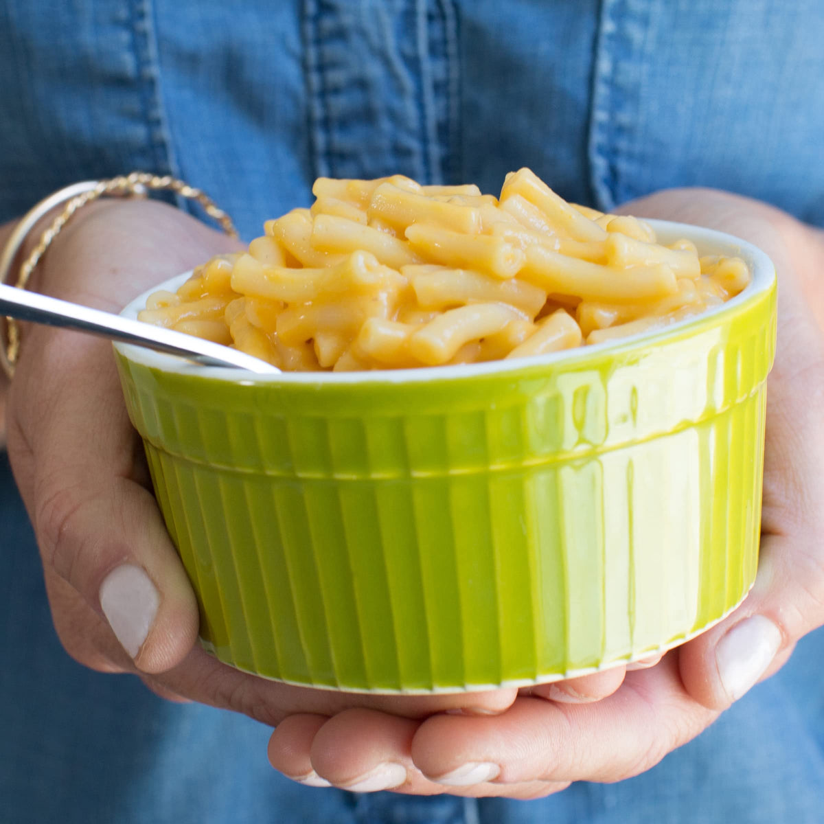 Pasta boiling on stove with Annie's vegan mac and cheddar