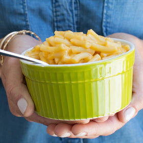 Pasta boiling on stove with Annie's vegan mac and cheddar