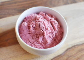 Anthony's Organic Pomegranate Powder packaging beside yogurt and spices.